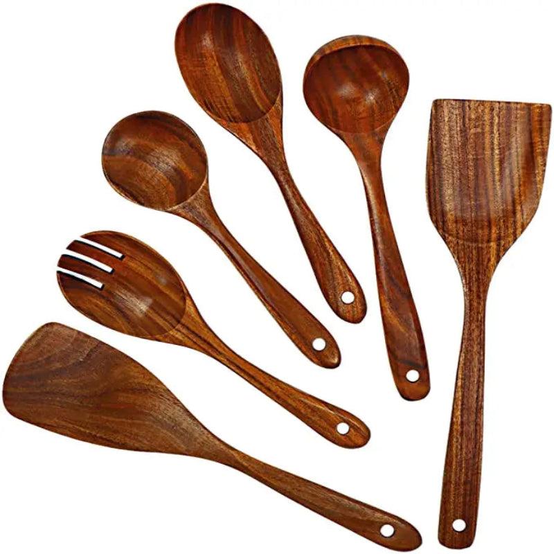 Set of wooden kitchen utensils including spoons and spatulas on a white background