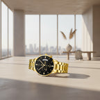 Gold wristwatch with black dial on a reflective surface