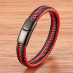 Red and black braided bracelet with a silver clasp on a wooden surface