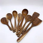 Set of wooden kitchen utensils on a white background
