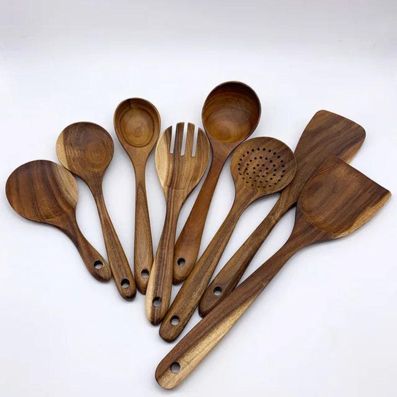Set of wooden kitchen utensils on a white background