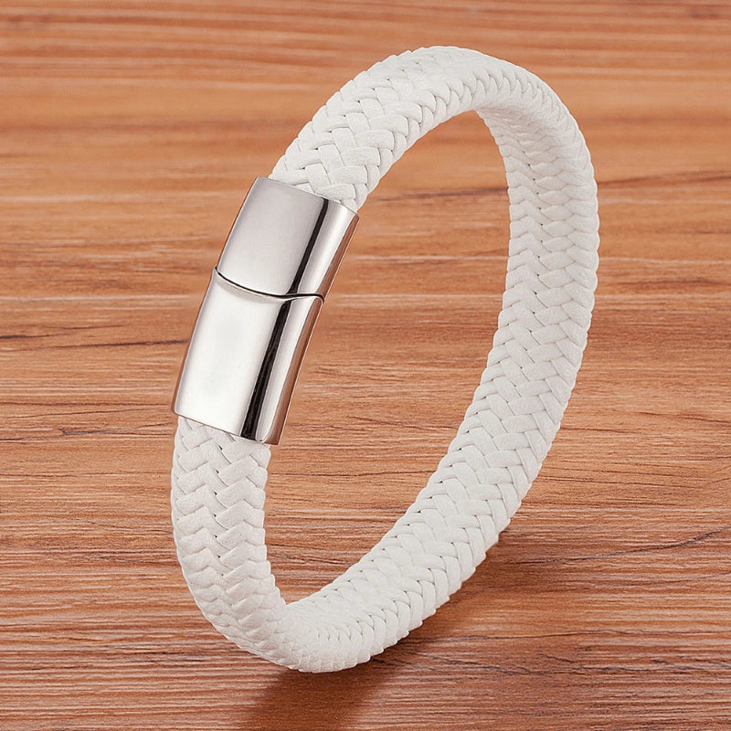 White braided bracelet with a silver clasp on a wooden surface
