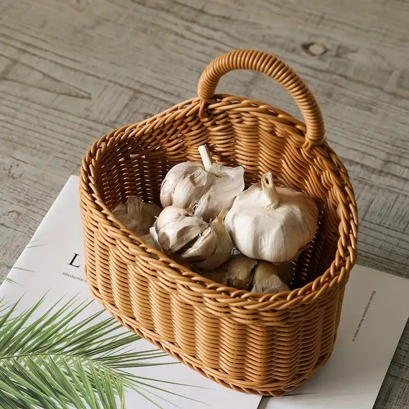 Wicker basket with garlic bulbs on a wooden surface