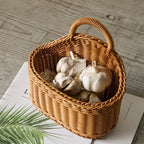 Wicker basket with garlic bulbs on a wooden surface