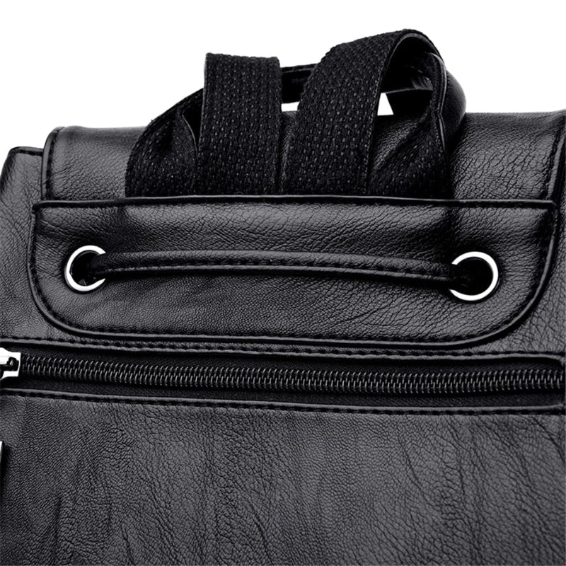 Close-up of a black leather bag with a zipper and strap on a white background