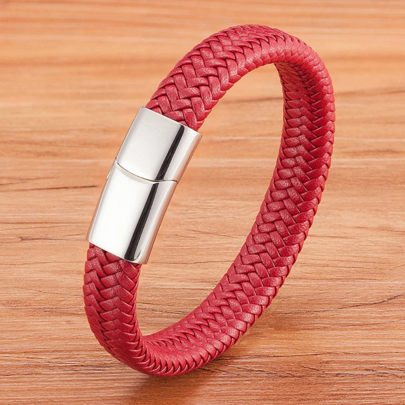 Red braided leather bracelet with a silver clasp on a wooden surface