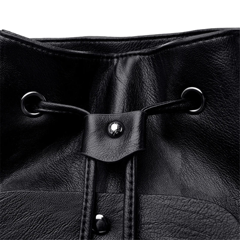 Close-up of a black leather drawstring bag with metal loops and buttons.