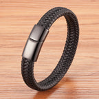 Black braided bracelet with a metallic clasp on a wooden surface