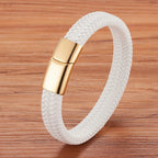 White braided bracelet with a gold clasp on a wooden surface