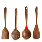 Set of four wooden kitchen utensils with handles on a white background