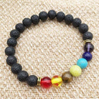 Black beaded bracelet with colorful beads on a textured beige background
