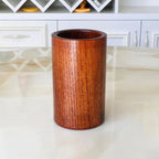 Wooden cylindrical object on a marble surface with a blurred background