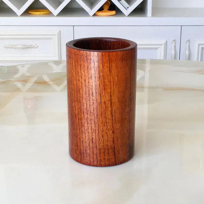 Wooden cylindrical object on a marble surface with a blurred background