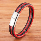Red and black braided bracelet with a silver clasp on a wooden surface