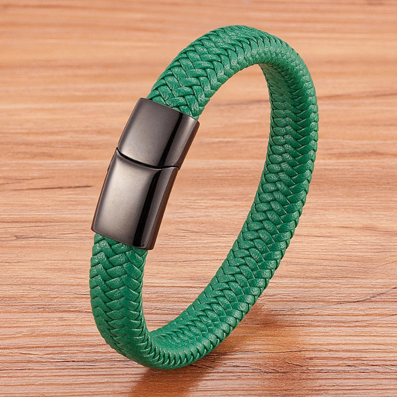 Green braided bracelet with a metallic clasp on a wooden surface