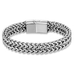 A silver-toned braided chain bracelet with a polished rectangular clasp, shown on a clean white background.