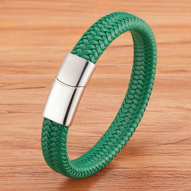 Green braided bracelet with a silver clasp on a wooden surface