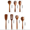 Set of wooden kitchen utensils with measurements on a white background