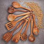 Set of wooden kitchen utensils on a gray surface with scattered lentils.