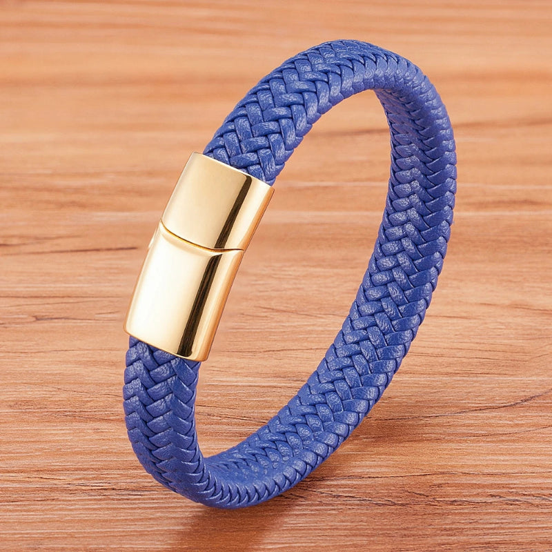 Blue braided bracelet with a gold clasp on a wooden surface
