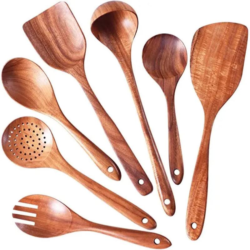 Set of wooden cooking utensils on a white background