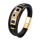 Black leather bracelet with gold accents on a white background