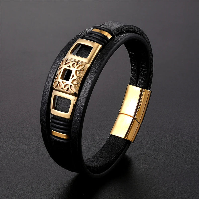 Black leather bracelet with gold accents on a dark gray background