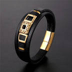 Black leather bracelet with gold accents on a dark gray background