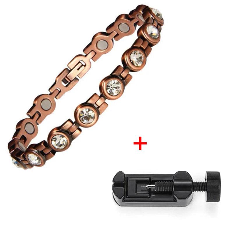 Copper chain bracelet with embedded crystals and a black tool on a white background