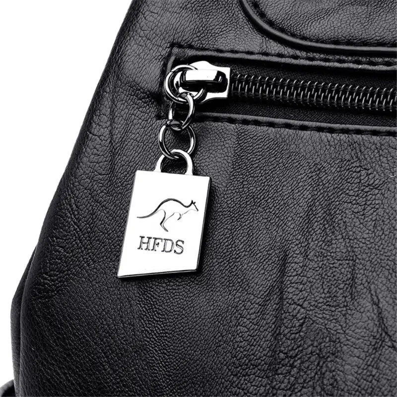 Black leather bag with a silver tag featuring 'HFDS' branding.