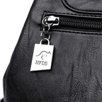 Black leather bag with a silver tag featuring 'HFDS' branding.