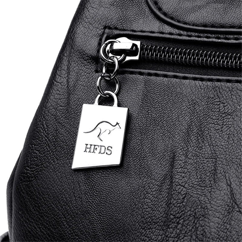 Black leather bag with a silver tag featuring 'HFDS' branding.
