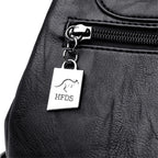 Black leather bag with a silver tag featuring 'HFDS' branding.