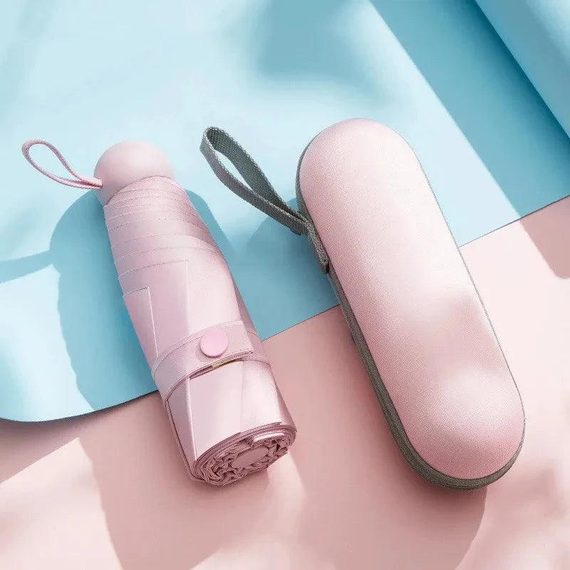 Pink umbrella and its case on a light blue and pink background
