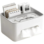 White desk organizer with glasses, notepad, and small device on a white background