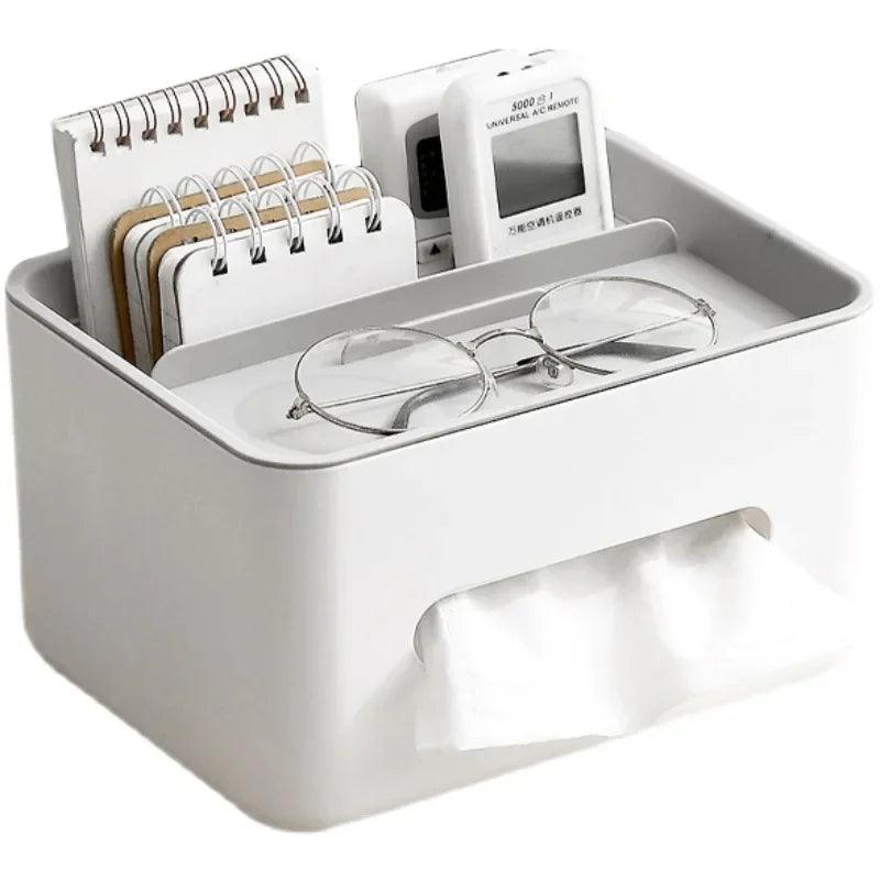 White desk organizer with glasses, notepad, and small device on a white background