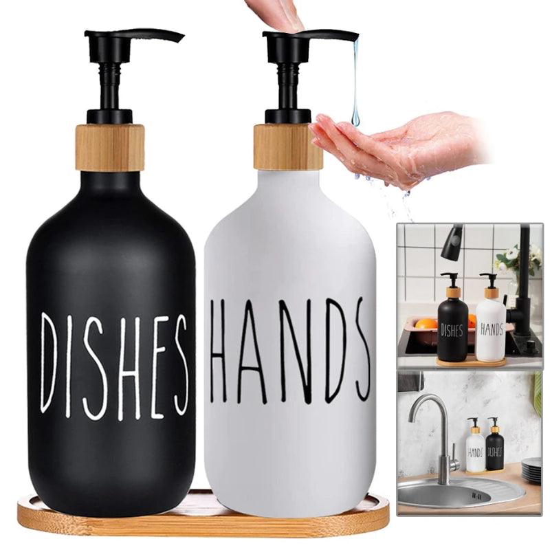 Two soap dispensers labeled 'Dishes' and 'Hands' on a wooden tray with a hand demonstrating use.
