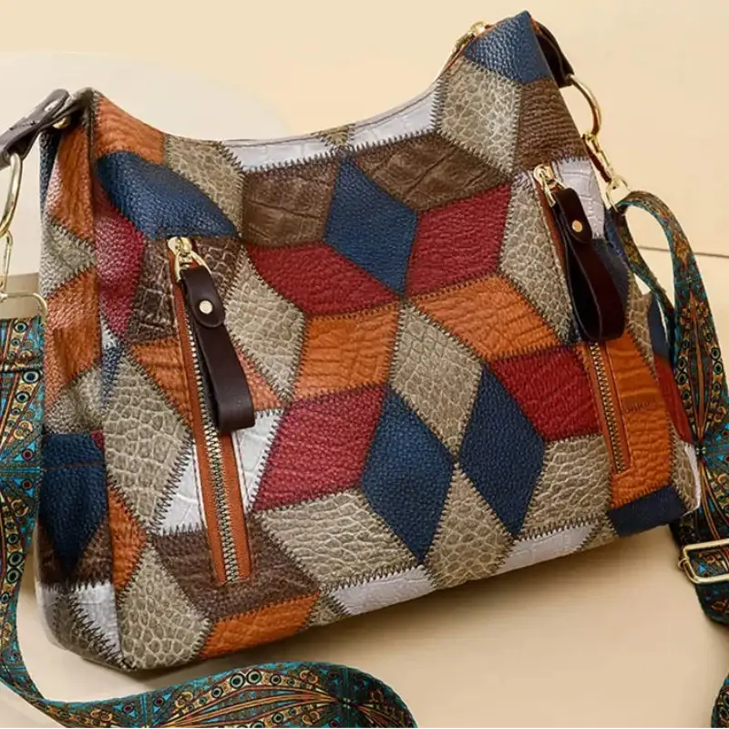 Multicolored patchwork handbag with a strap on a beige background, featuring the brand 'MANTIS SHRIMP'.