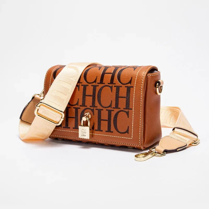 Brown handbag with beige strap and 'CHC' branding on a light gray background