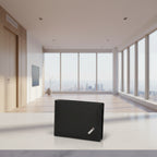 Black wallet with a brand logo on a wooden surface next to a brown leather belt.