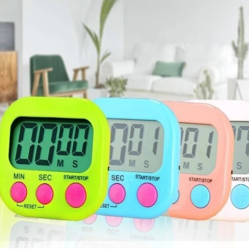 Four digital kitchen timers in lime green, light blue, peach, and white, arranged in a row. The background is a blurred living room with the text 'Digital Timer For Cooking Egg Study Classroom Kids' at the top.