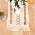 Decorative table runner with floral arrangement on a wooden surface