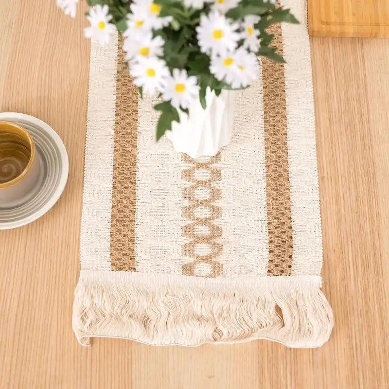 Decorative table runner with floral arrangement on a wooden surface