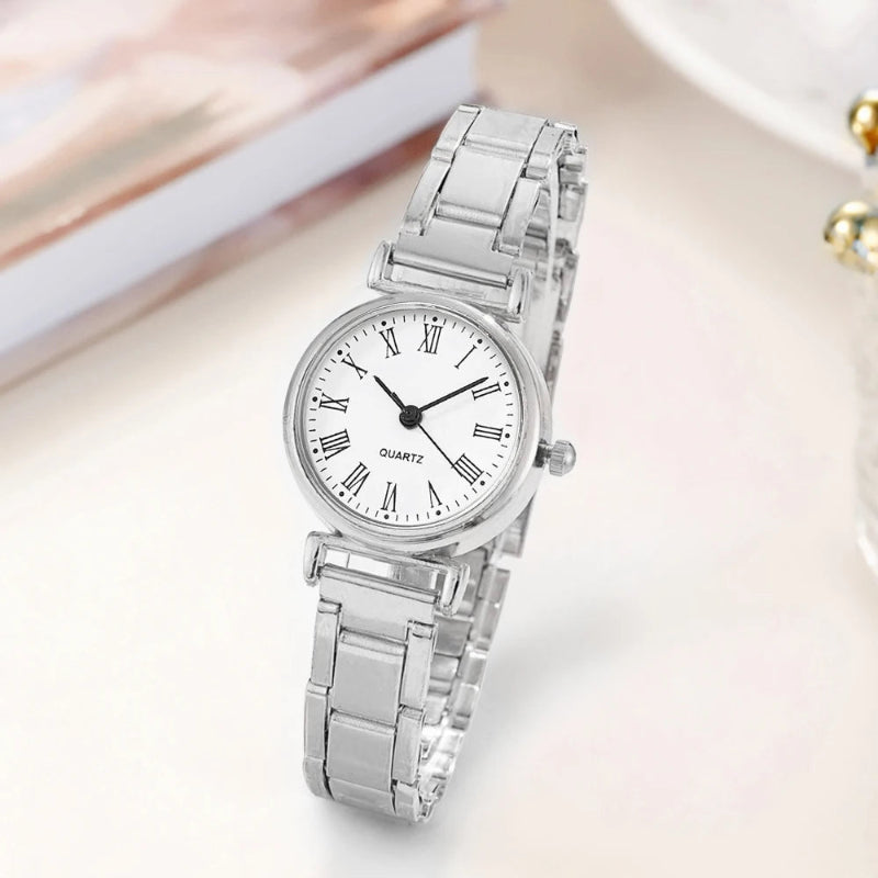 Silver wristwatch with a white dial on a light background