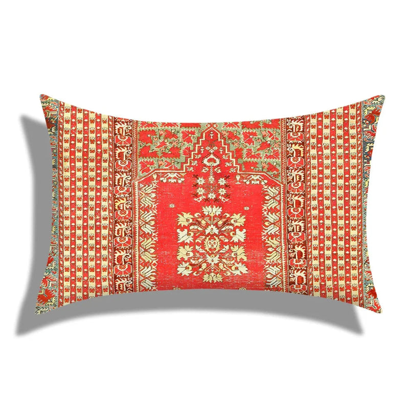 Decorative pillow with intricate red and gold pattern on a white background