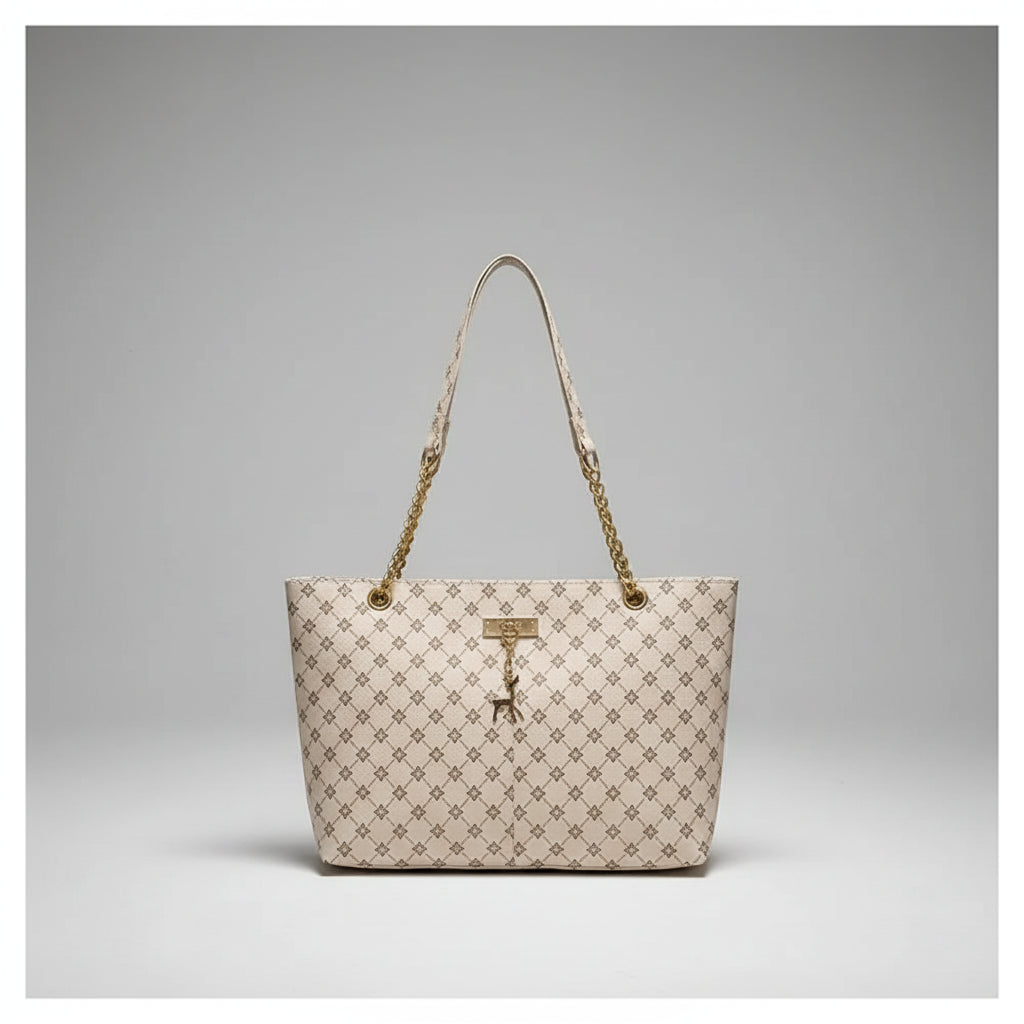 Beige handbag with gold chain strap hanging on a white door handle.