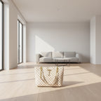 Patterned handbag with gold chain straps on a wooden surface