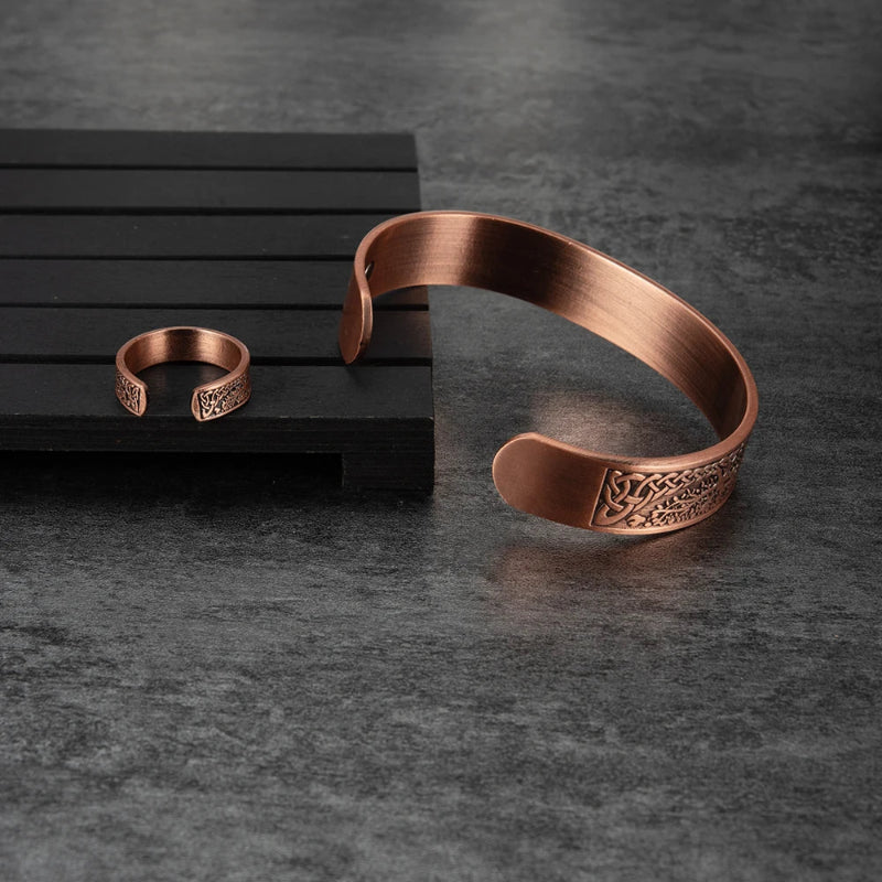 Copper bracelet and ring on a dark surface