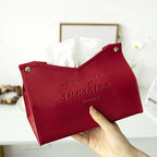 Red pouch with 'sunshine' text held by a hand against a blurred indoor background