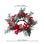 A festive Christmas wreath with red poinsettias, red berries, green leaves, pinecones, and frosted silver branches, shown with dimension lines indicating a width of 25cm (9.84 inches) and a top height of 7.